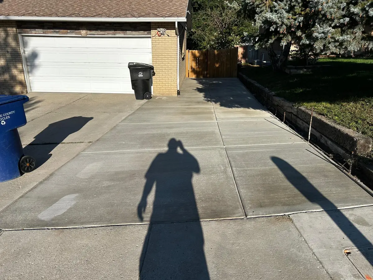 Concrete driveway with straight panel joints outside a garage