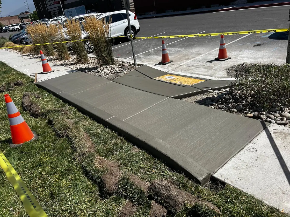 New concrete corner walkway beside a residential street