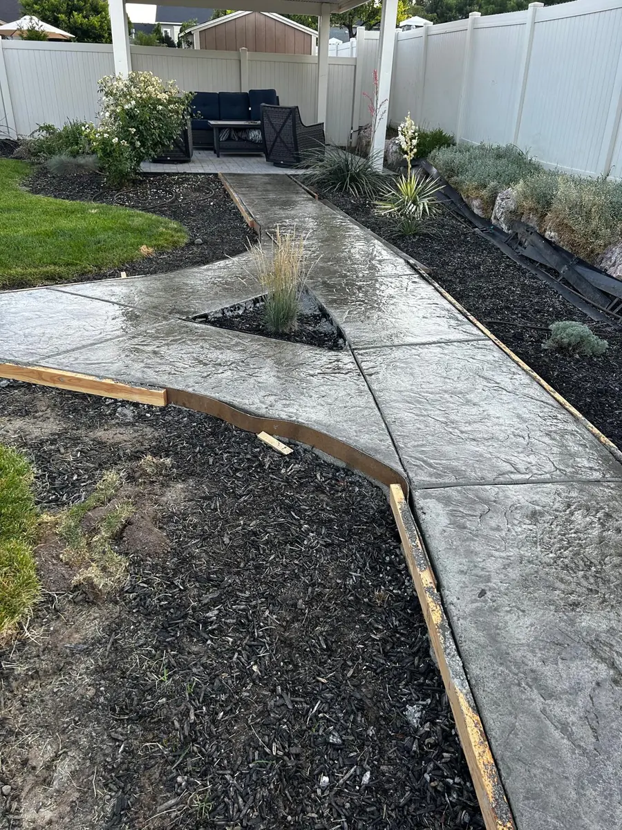 Textured concrete garden path with a curved edge