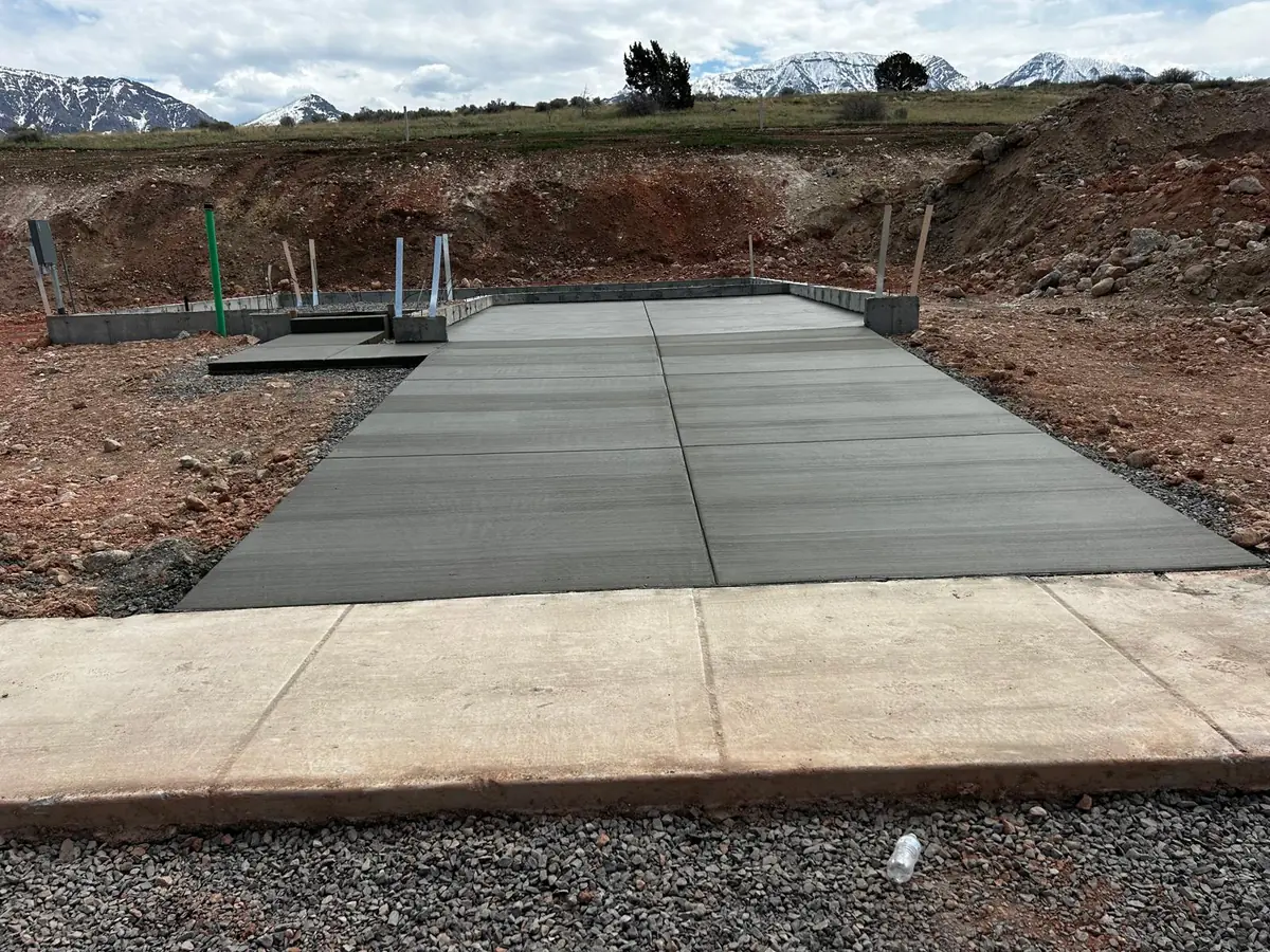 Broom-finished concrete slab beside foundation walls