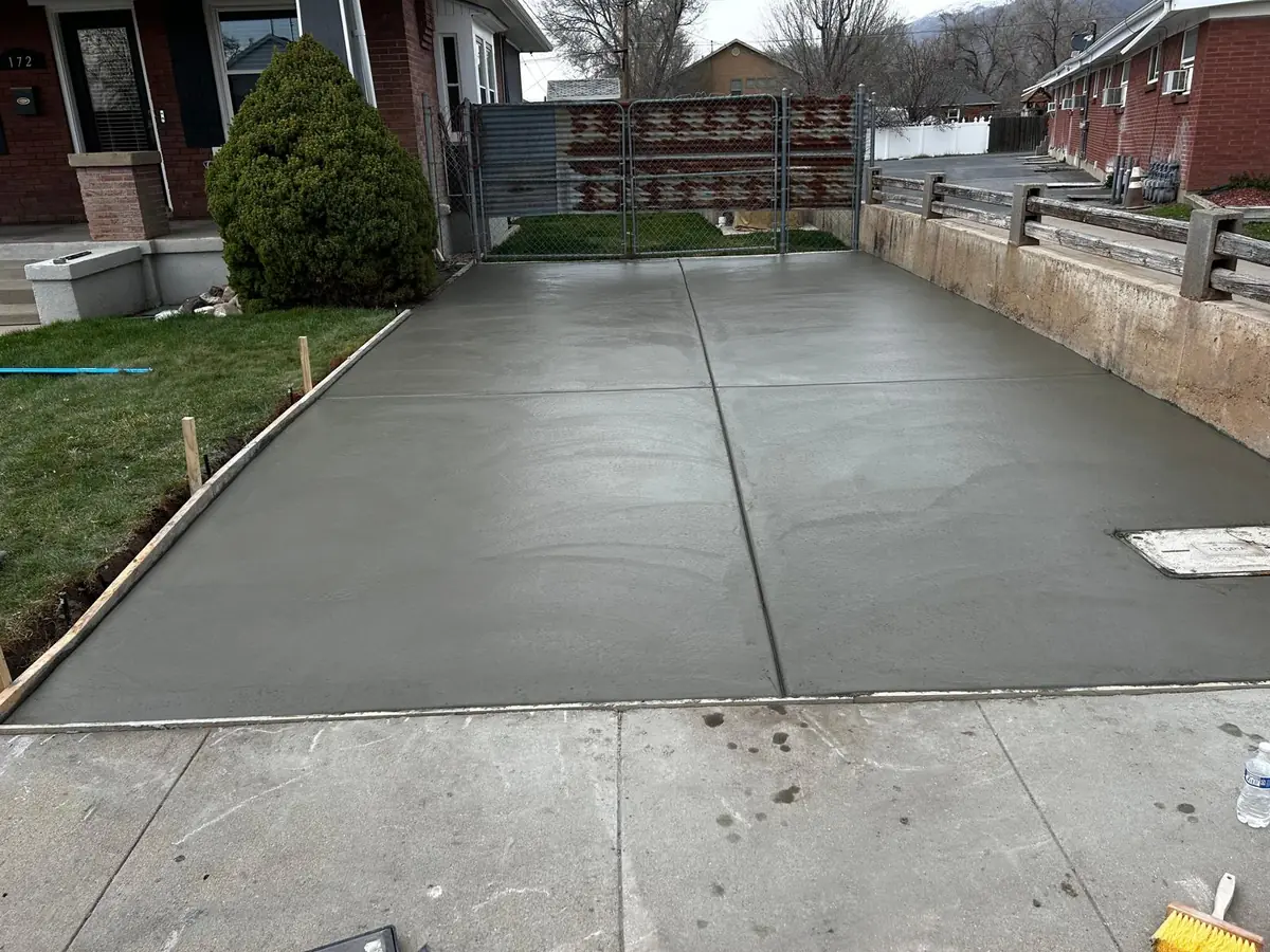 Wide residential concrete driveway with a defined perimeter