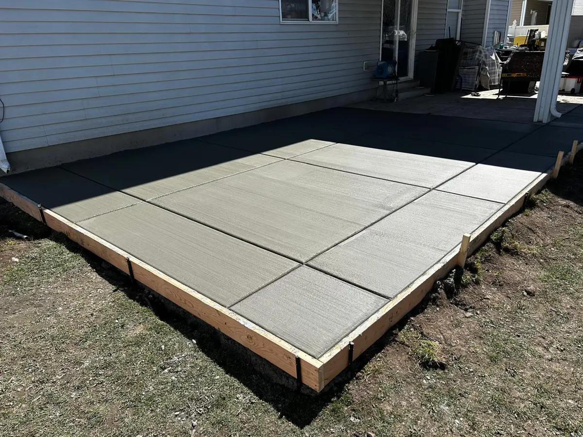 Concrete patio corner showing straight forms and control joints